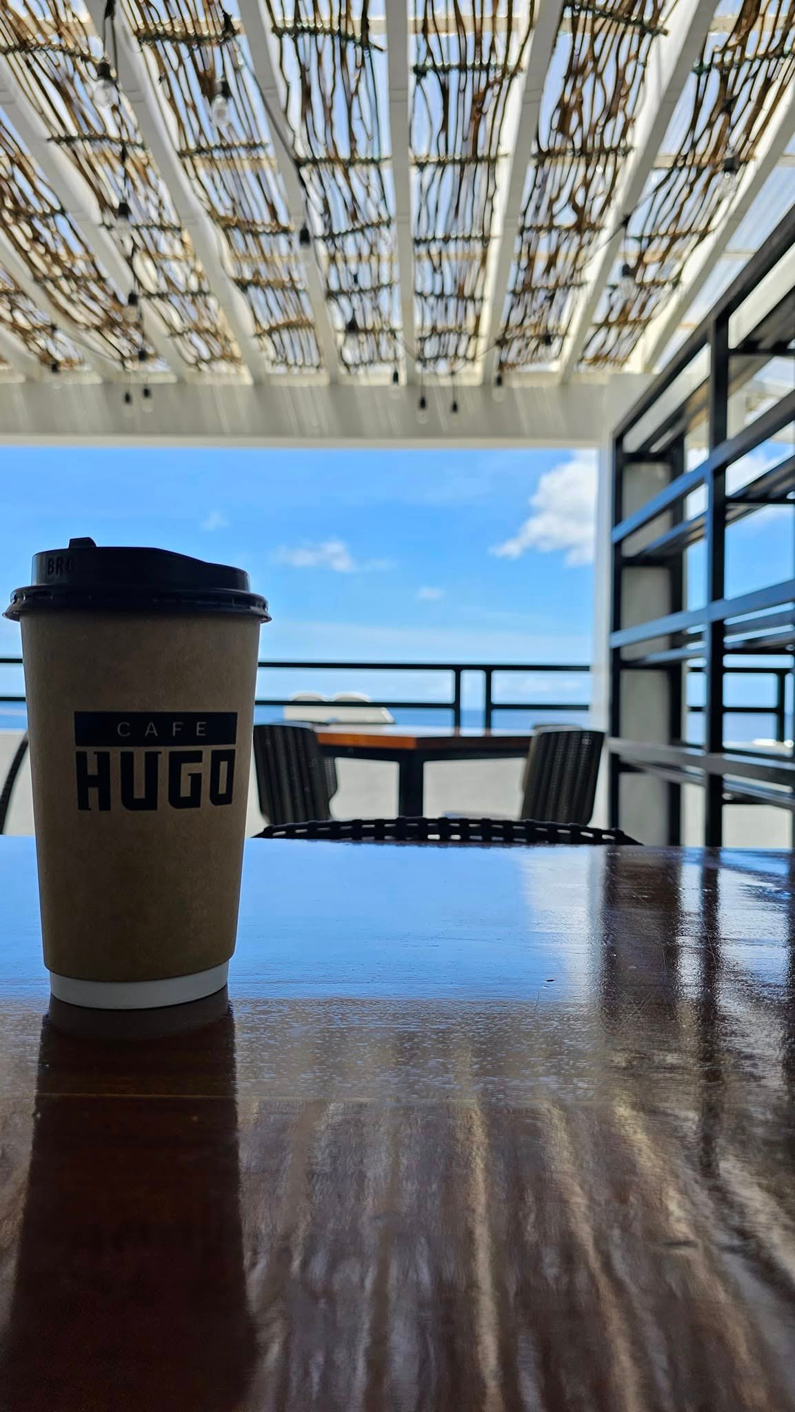 Café Hugo’s woven ceiling and open-air seating overlooking the coast